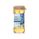 Bottle of Apidear Kashmiri White Honey with a jute cover on a white background