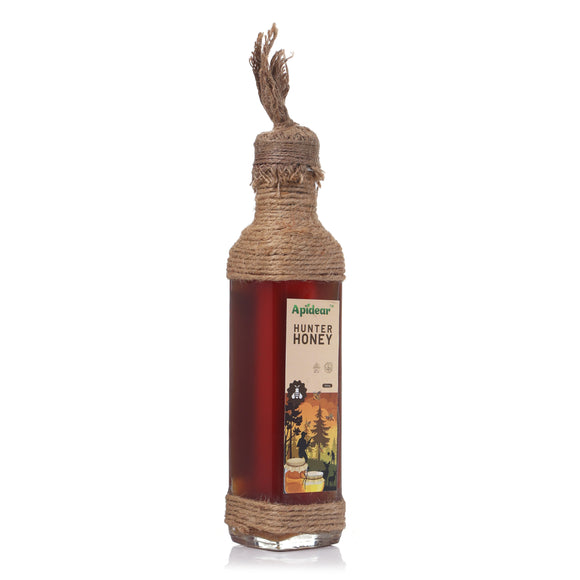 Bottle of Apidear Hunter Honey with a rope handle on a white background
