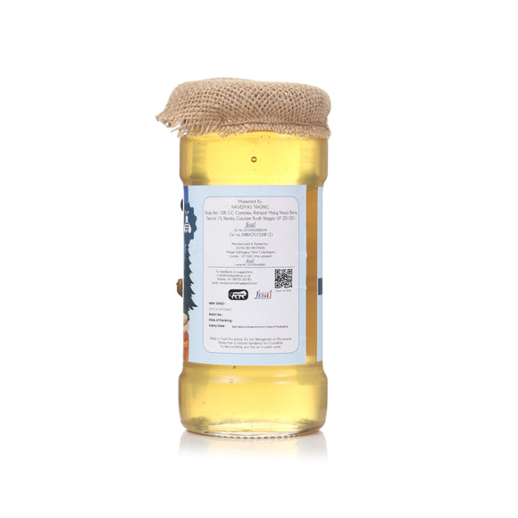 Jar of honey with a burlap cover on a white background