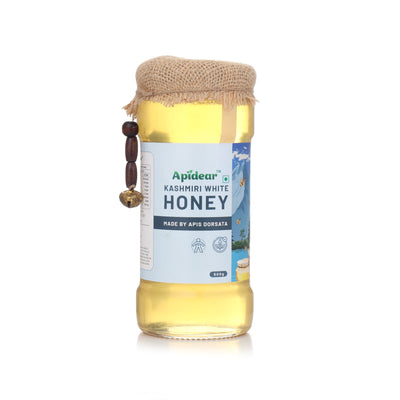 Bottle of Apidear Kashmiri White Honey with a jute cover on a white background